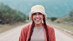 Outdoor, road and face of woman with smile in nature for vacation, travel and adventure at countryside. Person, relax and happy with hat in pride for journey, holiday and tourism in New Zealand