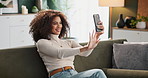 Happy woman, relax and sofa with selfie for photography, picture or memory in living room at home. Young female person with smile in relax for capture moment, post or snap on lounge couch at house