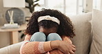 Sad, little girl and lonely with stress on sofa from abuse, anxiety or depression at home. Upset female person, child or kid in mental health, frustration or distress on living room couch at house