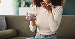 Drinking water, hands and tablet with woman in living room of home for medicine treatment of illness or symptoms. Healthcare, medical and pill with sick person drinking medication in apartment