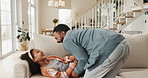 Love, tickle and man with kid on sofa for bonding, affection and support in child development. Playful, home and dad with girl in living room for family game, humour and happiness on fathers day