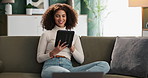 Woman, home and happy on sofa with tablet for social media media, post and watch videos for fun. Female person, couch and smile or laugh in lounge for entertainment, streaming service and website