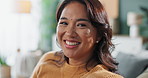 Face, home and Asian woman on couch, smile and happiness with weekend break, calm and peace in living room. Portrait, person and girl on sofa, cheerful and funny with humor, carefree and casual