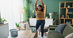Woman, headphones and crazy with dancing in home with music, radio and housework fun with freedom. Cleaner, person and energy with audio streaming for hygiene, throw and housekeeping in living room