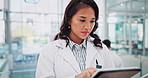 Asian woman, doctor and research with tablet at hospital for new discovery, cure or information. Female person, surgeon or medical professional browsing on technology for study of medicine at clinic
