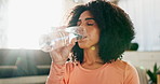 Yoga, black girl and drinking water in home for wellness, hydration and fitness break for nutrition or healthy habits. Woman, bottle and self care routine with lens flare and natural detoxification.