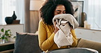 Smell, laundry and woman in home for cleaning, hygiene or housekeeping service on sofa in lounge. Scent, clothes and person with fresh fabric, textile or smile for cotton fragrance in washing basket