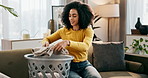 Home, basket and woman fold laundry, chore and hygiene with spring cleaning, housekeeping and routine. Person, apartment and girl with fresh clothes, fabric and container with duty, smile and washing