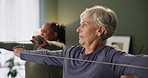 Resistance band, mature woman and exercise for physiotherapy, rehabilitation and wellness of body health. Physical therapy, happy people and stretching for fitness training in group class together