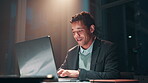 Businessman, happy and typing on laptop at night with project management deadline and strategy report in office. Professional, employee and smile for overtime with research article or task commitment