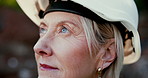 Woman, helmet and construction for thinking or planning, big idea for building or industry. Female person, engineering and closeup at work with thought for development, contractor in New York City