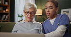 Senior woman, caregiver and laptop in home for help, support and care on sofa in living room. Elderly person, nurse and confused in house on couch for advice with internet, website and technology