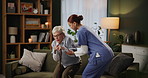 Nursing home, senior woman and professional with help in living room, assist and recovery from injury. People, caregiver and old person with walking stick, rehabilitation and fibromyalgia with pain