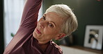 Mature woman, home and stretching for exercise, strength conditioning or workout. Female person, hands and living room for health goals with movement, commitment to fitness or wellness with smile