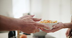 Person, cooking or hands of parent with healthy food for support, helping or sharing bowl in family home. Vegan diet, vegetables or closeup of people bonding in house kitchen for dinner meal dish