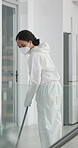 Woman, cleaning and disinfect with professional, team and sterilization for health care service. Office, germ protection and virus with safety suit or exposure, fumigation and hygiene for Covid19