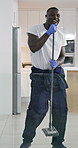 Office, man or cleaner with singing or music of podcast, house playlist and audio track while working. Black male employee, janitor and dancing while cleaning, mop floor and housekeeping service