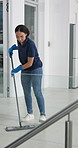 Sweeping, woman and cleaning for office, broom and solution for hygiene, maintenance and neat. Person, employee and maid in workplace, service and fresh with dust free space and spring cleaning