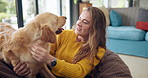 Happy woman, dog and play in home for care, love or friends bonding together in living room. Animal, girl or pet owner with golden retriever on sofa to relax, smile or connection for support in house