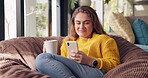 Girl, smartphone and morning relax in home with coffee for social media, trending news and scroll internet for post. Woman, bean bag and online for comfort or rest, peace and text communication.