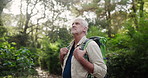 Senior, walking or man hiking in nature on adventure to explore on holiday vacation, trail or path. Wellness, trees or male hiker trekking in woods outdoors for travel journey or health in forest