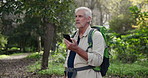 Lost, forest and senior man with phone for online gps, camping holiday and direction for hiking adventure. Mobile, nature park and elderly guy with search for trail location and digital map in Brazil