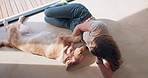 Playing, woman and dog on patio to relax with health, wellness and happy pet in home. Friends, girl and Golden Retriever on floor together with care, playful bonding and love for animal from above