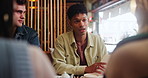 Man, team and meeting with documents at cafe for discussion on project or ideas at indoor restaurant. Young group of creative employees discussing workflow, tasks or startup together at coffee shop