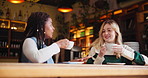 Women, coffee and conversation in cafe as friends with chat, gossip and funny news for social connect. Girls, latte and communication in New York restaurant in morning for reunion, relax and talking