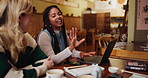 Woman, team and communication with laptop at cafe for meeting, discussion or project at indoor restaurant. Group of creative employees discussing workflow, tasks or startup on computer at coffee shop