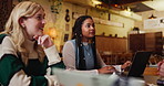 People, diversity and meeting with laptop at cafe for discussion on project or ideas at indoor restaurant. Young group of creative employees discussing workflow, tasks or startup at coffee shop
