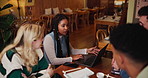 People, diversity and communication with laptop at cafe for meeting, discussion or project at indoor restaurant. Young group of creative employees discussing workflow, tasks or startup at coffee shop