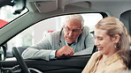 Woman, businessman and inside talking in car, transportation and explaining interior or safety features with customer in vehicle. Salesman, dealership and buyer in drivers seat, people and automobile
