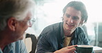 Coffee, conversation and man with grandfather on sofa for discussion, talking and chatting together. Family, senior and grandpa and grandson and drink for bonding, relationship and communication