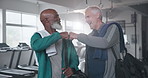 Fist bump, fitness and old men in gym, training and challenge with support, motivation and achievement. Healthy, wellness center and friends with hand gesture, happiness and progress with exercise