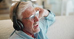 Singing, dance or senior man with headphones on sofa for music, fun and digital audio, playlist or streaming at home. Radio, earphones or old male in living room with retirement, celebration or sound