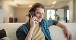Man, student and phone call on sofa in home with smile, listen and hello for conversation in lounge. Person, smartphone and contact on mobile network for chat, relax and happy in living room in house