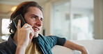 Man, relax and phone call on sofa in home with smile, listen and hello for conversation in lounge. Person, smartphone and contact on mobile network for chat, happy and couch in living room at house
