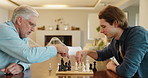 Chess, senior father and son with fun, men and bonding together with happiness, weekend break and hobby. Chatting, board game and relax with family, elderly man and people with skills, home or talent