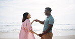 Couple, outdoor and dancing with love by sea for freedom on romantic holiday, travel and bonding in California. Man, woman and together with movement on vacation by beach waves, happy and support.