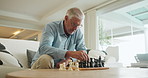 Senior man, chess and game in home on sofa with strategy, solution and memory exercise in living room. Elderly person, toys and board for games with king, queen and knight with challenge in lounge