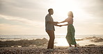 Couple, outdoor and dancing with fun on beach for freedom on romantic holiday, travel and bonding in California. Man, woman and together with movement on vacation by ocean waves, happy and sun flare.