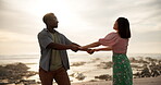 Couple, celebration and dance on beach with outdoor romance, holiday and vacation by ocean. Happy people spinning and holding hands with love, fun or travel on anniversary or valentines day by sea