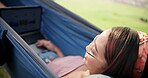 Hammock, woman and typing on laptop in outdoor, remote work and planning on website for agenda. Female person, relax and journalist for research on article, editing and networking on app for project