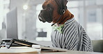 Office, service and dog with laptop, headset and online networking for support animal at desk. Consultant, agent or Boxer at computer at call center with professional career in pet friendly workplace