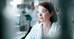 Scientist, woman and technology with ppe in laboratory for research, analysis and innovation at night. Computer, development and female medical professional in clinic for inspection or check results