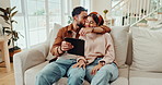 Happy, home and couple with tablet on sofa for online post, social media and bonding on weekend. Dating, living room and man and woman on digital tech for streaming, website and relax together