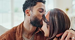 Happy, couple and home with kiss on forehead with love, care and marriage with an embrace. House, relax and living room with smile, happy and romance together on a sofa with support and bonding