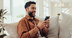 Phone, text and man in a home with social media, internet and website scroll on a lounge sofa. Video, meme and smile relax at a home with news app, streaming and typing online for web post comment