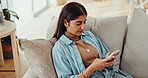 Happy, woman and smartphone on sofa for messaging, entertainment and social media at home. Smile, female person and mobile with funny joke, internet meme or chat on couch to relax and rest on holiday